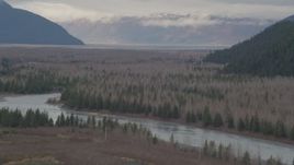 4K aerial stock footage flying by the river valley, tilt down to the river, Portage, Alaska Aerial Stock Footage | AK0001_0509