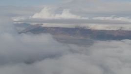 4K aerial stock footage fly by low clouds over Kenai Mountains, Turnagain Arm of the Cook Inlet, Alaska Aerial Stock Footage | AK0001_0532