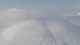 4K aerial stock footage flying by low clouds on the summit, Kenai Mountains, Alaska Aerial Stock Footage | AK0001_0533