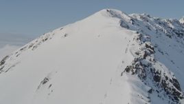 4K aerial stock footage ascending a snowy ridge, flying along the slopes, Kenai Mountains, Alaska Aerial Stock Footage | AK0001_0542