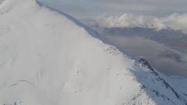 4K aerial stock footage approaching and ascending snowy ridge towards summit, Kenai Mountains, Alaska Aerial Stock Footage | AK0001_0544