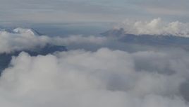 4K aerial stock footage pan by Chugach Mountains, low clouds, Turnagain Arm of the Cook Inlet, Alaska Aerial Stock Footage | AK0001_0546
