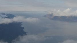 4K aerial stock footage fly by mountains, low clouds over the Turnagain Arm of the Cook Inlet, Alaska Aerial Stock Footage | AK0001_0548