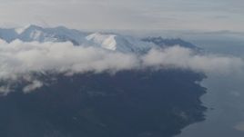 4K aerial stock footage fly by low clouds, Turnagain Arm of the Cook Inlet, and Kenai Mountains, Alaska Aerial Stock Footage | AK0001_0549