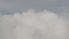 4K aerial stock footage approaching low, thick clouds, Chugach Mountains, Alaska Aerial Stock Footage | AK0001_0555