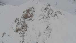 4K aerial stock footage orbiting a snowy summit, Chugach Mountains, Alaska Aerial Stock Footage | AK0001_0576