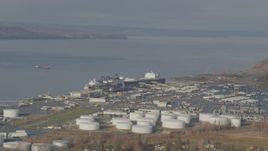 4K aerial stock footage large tanks and a cargo ship at the port, Anchorage, Alaska Aerial Stock Footage | AK0001_0584