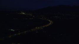 4K aerial stock footage flying over Glenn Highway, approach Chugach Mountains, Anchorage, Alaska, night Aerial Stock Footage | AK0001_0603