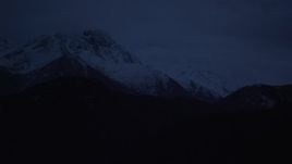 4K aerial stock footage flying by snow-capped Chugach Mountains, Alaska, sunrise Aerial Stock Footage | AK0001_0608