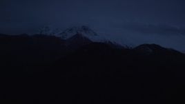 4K aerial stock footage approaching snow-capped Chugach Mountains, Alaska, sunrise Aerial Stock Footage | AK0001_0609