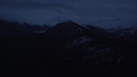 4K aerial stock footage flying by snow-capped Chugach Mountains, Alaska, sunrise Aerial Stock Footage | AK0001_0611