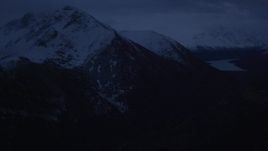 4K aerial stock footage fly by snowy Chugach Mountains, Eklutna Lake, Chugach Mountains, Alaska, sunrise Aerial Stock Footage | AK0001_0612