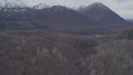 4K aerial stock footage flying over wooded hills, approaching Chugach Mountains, Birchwood, Alaska Aerial Stock Footage | AK0001_0623