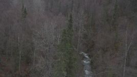 4K aerial stock footage flying over forested hills, tilt down on river, Birchwood, Alaska Aerial Stock Footage | AK0001_0637
