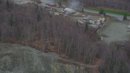 4K aerial stock footage approaching rock quarry, tilt down to heavy equipment and buildings, Chugiak, Alaska Aerial Stock Footage | AK0001_0651