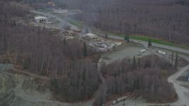 4K aerial stock footage fly away from rock quarry, hillside with excavator, Chugiak, Alaska Aerial Stock Footage | AK0001_0655