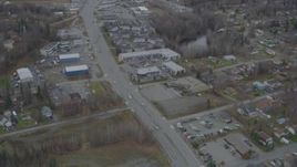 4K aerial stock footage Old Glenn Highway through town, tilt up to reveal shops, Eagle River, Alaska Aerial Stock Footage | AK0001_0663