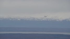 4K aerial stock footage E-3 Sentry coming in for landing, snowy mountains, Fort Richardson, Alaska Aerial Stock Footage | AK0001_0670