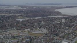 4K aerial stock footage flying over residential buildings to Westchester Lagoon, Anchorage, Alaska Aerial Stock Footage | AK0001_0675