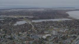 4K aerial stock footage flying over residential buildings to Westchester Lagoon, Anchorage, Alaska Aerial Stock Footage | AK0001_0676