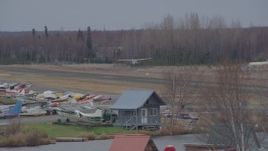 4K aerial stock footage tracking small plane taking off, Lake Hood Seaplane Base, Anchorage, Alaska Aerial Stock Footage | AK0001_0686