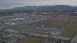 4K aerial stock footage approaching distant snow-capped mountains, Merrill Field, Anchorage Aerial Stock Footage | AK0001_0691