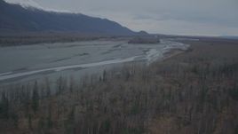 4K aerial stock footage flying along river bank, approaching small island, during winter, Knik River, Alaska Aerial Stock Footage | AK0001_0696