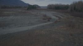 4K aerial stock footage flying low over riverbed, trees, during winter, Knik River, Alaska Aerial Stock Footage | AK0001_0699