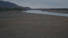 4K aerial stock footage flying low over grassland, approaching river, winter, Knik River, Alaska Aerial Stock Footage | AK0001_0700