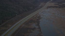 4K aerial stock footage following highway by marshlands, forest, during winter, Glenn Highway, Alaska Aerial Stock Footage | AK0001_0707