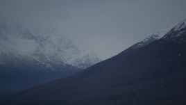 4K aerial stock footage flying by snow-capped peaks, bordering valley, Chugach Mountains, Alaska Aerial Stock Footage | AK0001_0715