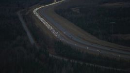 4K aerial stock footage approaching accident backing up traffic on Glenn Highway, Alaska, twilight Aerial Stock Footage | AK0001_0718