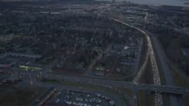 4K aerial stock footage following Glenn Highway, revealing Downtown Anchorage, Alaska, twilight Aerial Stock Footage | AK0001_0723