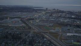 4K aerial stock footage flying by Glenn Highway, reveal Merrill Field, Downtown Anchorage, Alaska, twilight Aerial Stock Footage | AK0001_0724