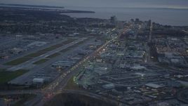 4K aerial stock footage flying over large stores by Glenn Highway, revealing Downtown Anchorage, Alaska, twilight Aerial Stock Footage | AK0001_0725