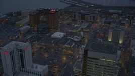 4K aerial stock footage flying by Hotel Captain Cook and office buildings in Downtown Anchorage, Alaska, sunset Aerial Stock Footage | AK0001_0729