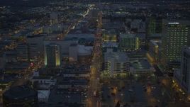 4K aerial stock footage following West 6th Ave, during winter, through Downtown Anchorage, Alaska, night Aerial Stock Footage | AK0001_0736