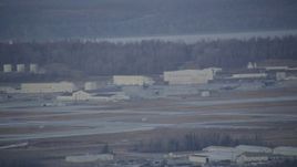 4K aerial stock footage a view of hangars, aircraft in winter, Elmendorf Air Force Base, Anchorage Aerial Stock Footage | AK0001_0741