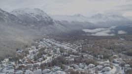 4K aerial stock footage snowy residential neighborhood Eagle River Valley, wooded hill, Eagle River, Alaska Aerial Stock Footage | AK0001_0752