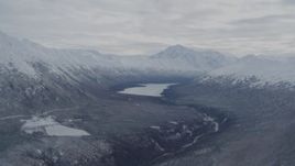 4K aerial stock footage flying by snowy Chugach Mountains and Eklutna Lake, Alaska Aerial Stock Footage | AK0001_0774