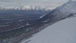 4K aerial stock footage approaching snowy ridge, revealing a river valley, Chugach Mountains, Alaska Aerial Stock Footage | AK0001_0778