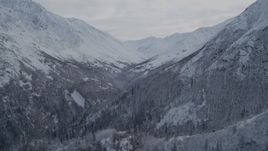 4K aerial stock footage fly by narrow valley, snowy Chugach Mountains, Alaska Aerial Stock Footage | AK0001_0784