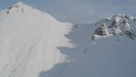 4K aerial stock footage flying low over snowy ridge, revealing Chugach Mountains, Alaska Aerial Stock Footage | AK0001_0794