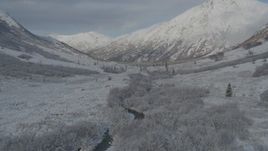 4K aerial stock footage descending into frosty valley, snow-covered Chugach Mountains, Alaska Aerial Stock Footage | AK0001_0801