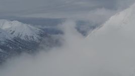 4K aerial stock footage flying into clouds, over snowy Chugach Mountains, Alaska Aerial Stock Footage | AK0001_0813
