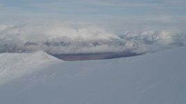 4K aerial stock footage over snowy ridge, reveal Matanuska River Valley, Chugach Mountains, Alaska Aerial Stock Footage | AK0001_0816