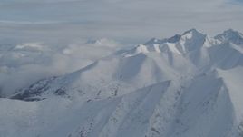 4K aerial stock footage clouds, snow-covered Chugach Mountains, Alaska Aerial Stock Footage | AK0001_0817