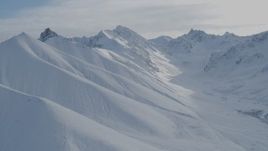4K aerial stock footage approaching snowy slopes, descend into valley, Chugach Mountains, Alaska Aerial Stock Footage | AK0001_0822