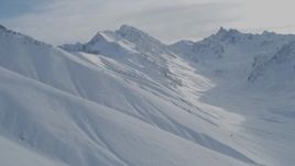 4K aerial stock footage flying over snowy slopes, descend into valley, Chugach Mountains, Alaska Aerial Stock Footage | AK0001_0823