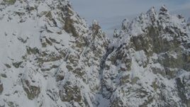 4K aerial stock footage flying over snowy, rocky ridge, reveal ranges, Chugach Mountains, Alaska Aerial Stock Footage | AK0001_0831